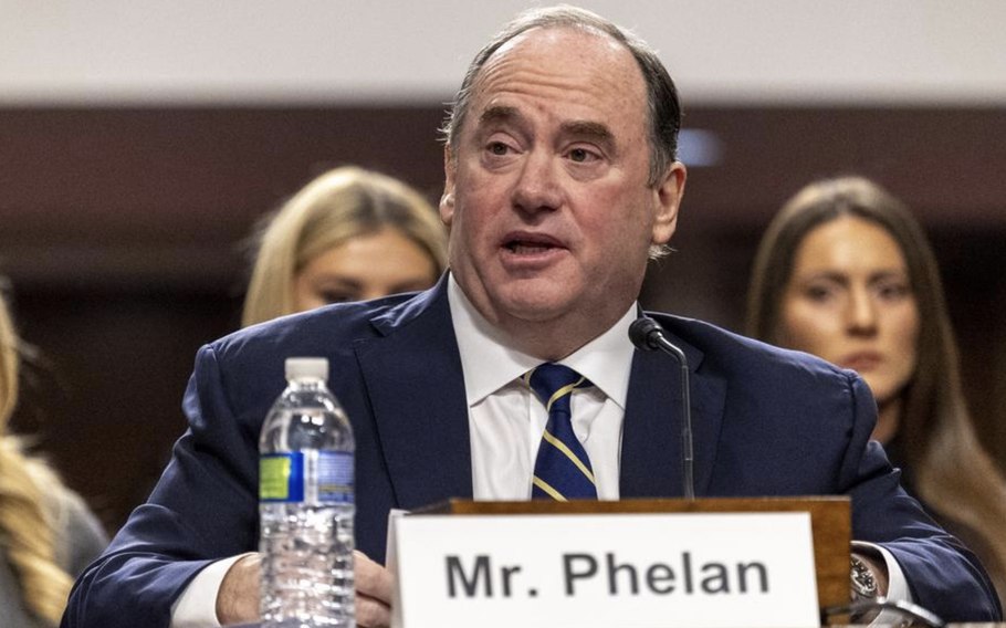 John Phelan sitting and speaking during a hearing.