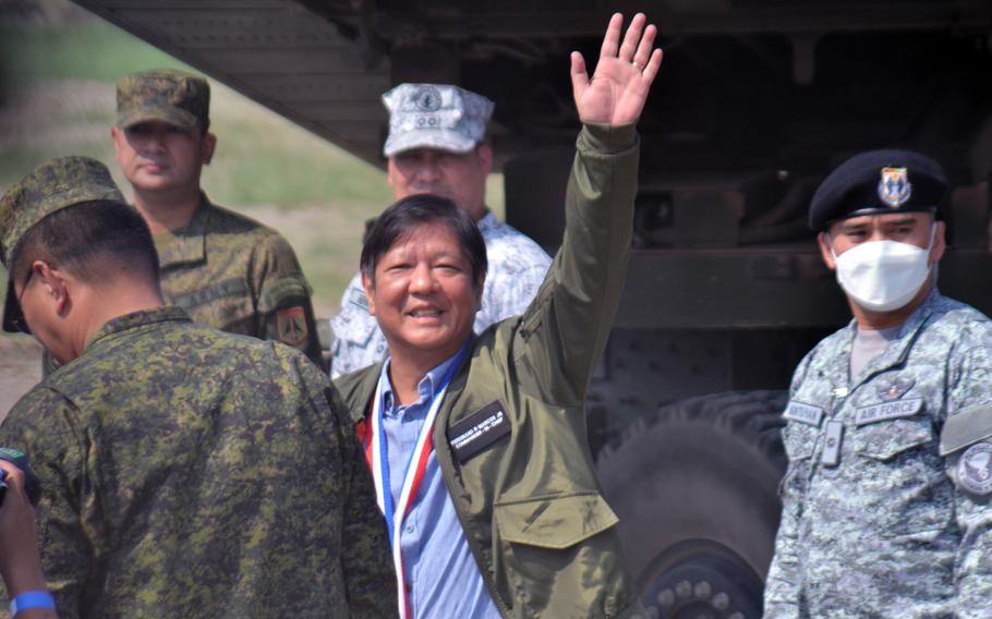 Philippines President Ferdinand Marcos Jr. waves to reporters during a Balikatan live-fire drill in San Antonio, Philippines, April 26, 2023.
