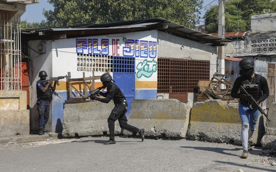 National Police patrol the area near the empty National Penitentiary after a small fire inside the jail in downtown Port-au-Prince, Haiti, Haiti, Thursday, March 14, 2024. This is the same prison that armed gangs stormed late March 2 and hundreds of inmates escaped. (AP Photo/Odelyn Joseph)