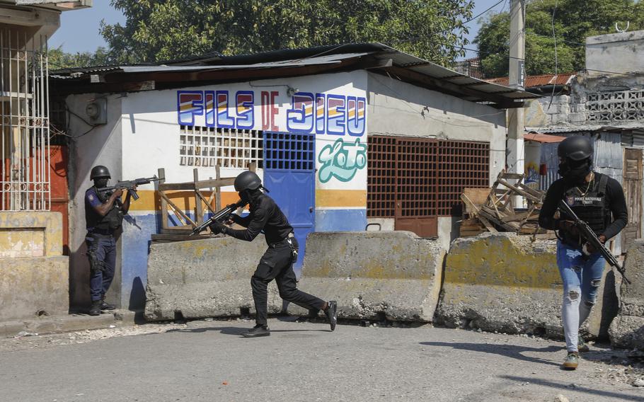 National Police patrol the area near the empty National Penitentiary after a small fire inside the jail in downtown Port-au-Prince, Haiti, on Thursday, March 14, 2024. This is the same prison that armed gangs stormed March 2 and hundreds of inmates escaped.