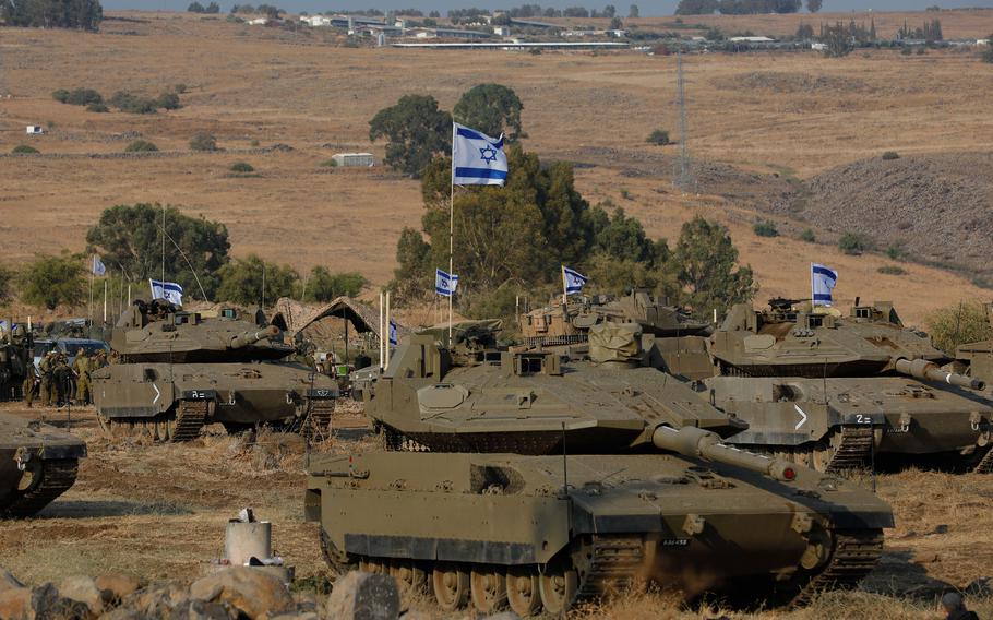 Israeli Merkava tanks are positioned in the upper Galilee in northern Israel near the border with Lebanon on Oct. 11, 2023. Israel appeared to be readying for a possible ground invasion of Gaza, but faces the threat of a multi-front war after also coming under rocket attack from militant groups in neighboring Lebanon and Syria.