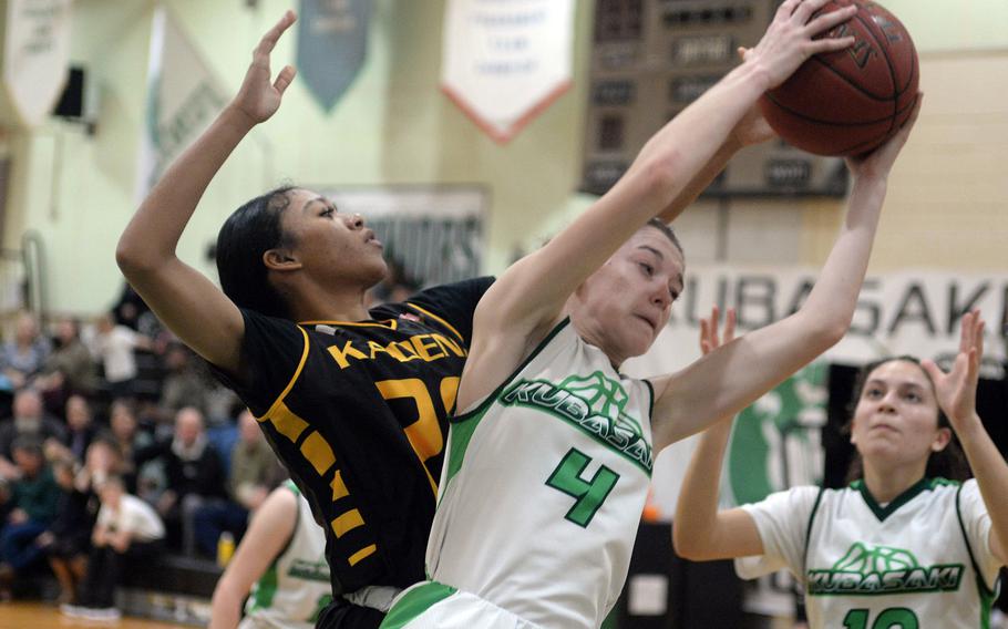 Kubasaki's Adria Lockhart pulls down a rebound in front of Kadena's Ayanna Levi during Thursday's Okinawa girls basketball game. The Panthers won 43-29.