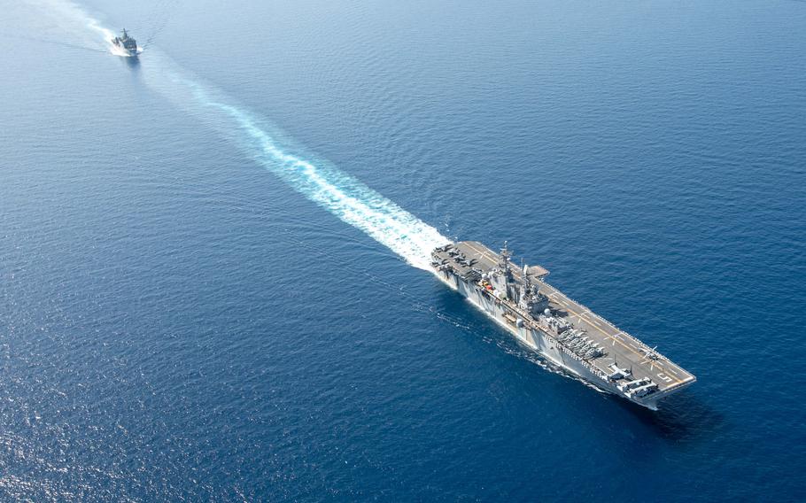 The amphibious assault ship USS Bataan and dock landing ship USS Carter Hall sail together in the Red Sea on Aug. 8, 2023. The U.S. sent ships into the area in August because of a resurgence of tensions with Iran.