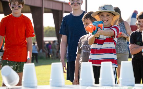 A child fires a water gun.
