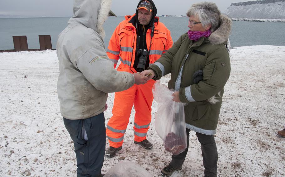 Karina Nielsen Kastberg, a Danish nurse on a one-year assignment to Thule, buys a five-pound hunk of musk ox from local Inuit people visiting the base to demonstrate their culture.