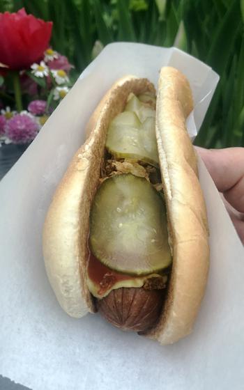 The classic hot dog at the Hamburger am Turm is served with ketchup, mustard, roasted onions and pickles. They also offer it with other toppings like kraut or chili and cheese. 