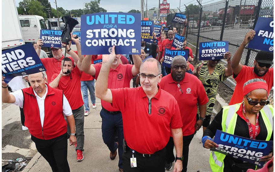 UAW President Shawn Fain marches with union members during practice picket, no work stoppages, employees report to shifts as usual, outside the Stellantis Detroit Assembly Complex in Detroit, on Aug. 22, 2023.  