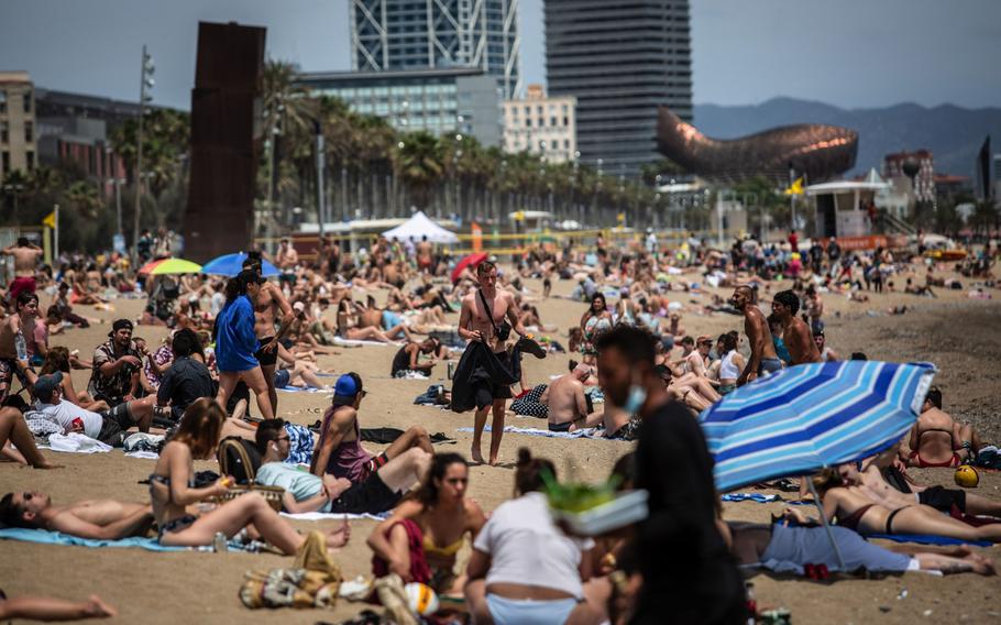 Visitors sunbathe on Barceloneta beach in Barcelona, Spain, on June 5, 2021. 