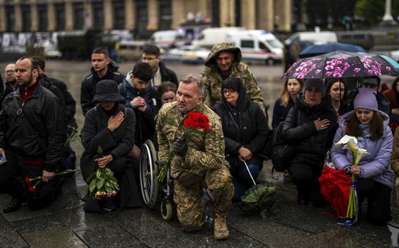 Family, friends and military comrades gather to mourn Ukrainian army paramedic Nazarii Lavrovskyi, 31, during his funeral ceremony in Kyiv on April 24, 2024.