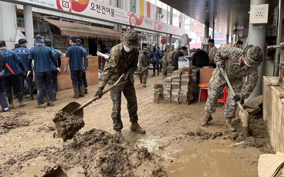 Service members clear mud and debris from Ocheon Market in Pohang, South Korea, Wednesday, Sept. 7, 2022, in the wake of Typhoon Hinnamnor. 