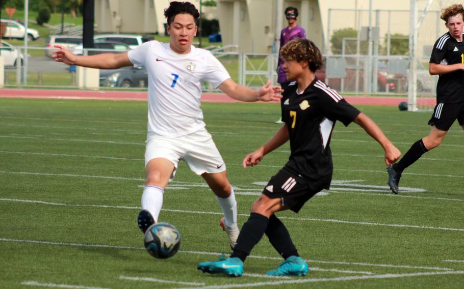 Kadena's Landon Reyes boots the ball against CAJ's Takatoshi Kanemura.