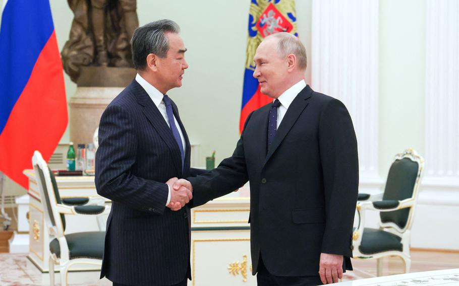 Russian President Vladimir Putin meets with China’s Director of the Office of the Central Foreign Affairs Commission Wang Yi at the Kremlin in Moscow on Feb. 22, 2023.