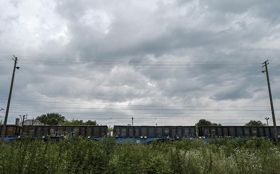 A train passes along a stretch of railway in Buszkowiczki near where officials say a video camera to surveil cargo movements was found on a tree. 