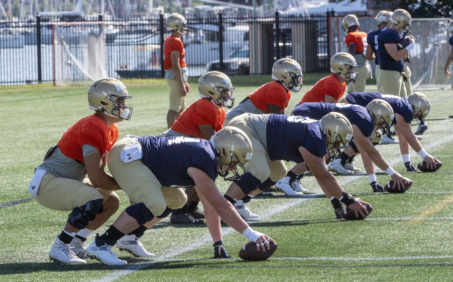 Navy quarterbacks, from left, Tai Lavatai, King Benford, Maasai Maynor and Zachary Branam during practice at the U.S. Naval Academy in Annapolis, Md., on Aug. 23, 2022. 