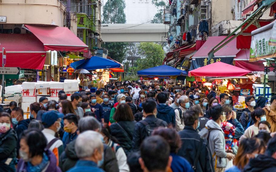 Crowds are seen at a wet market in Hong Kong on Feb. 28, 2022.