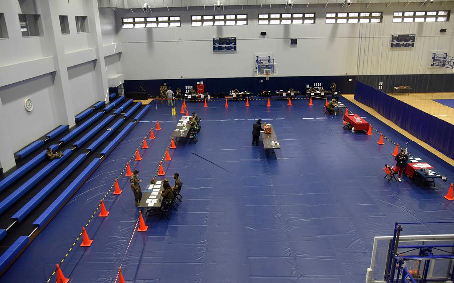 Family members and other nonessential personnel are processed through an evacuation control center during a mandatory three-day exercise at Marine Corps Air Station Iwakuni, Japan, Oct. 13, 2021.