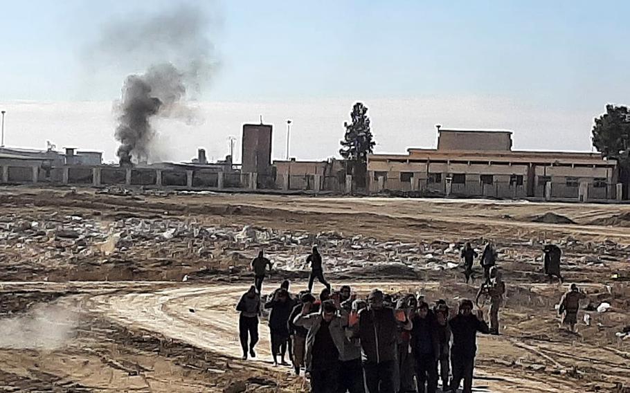 Detainees are marched down a road by Syrian Democratic Forces members near Hassakeh, Syria, following an attack by Islamic State militants on a prison. The attack, which began Jan. 20, lasted 10 days. 