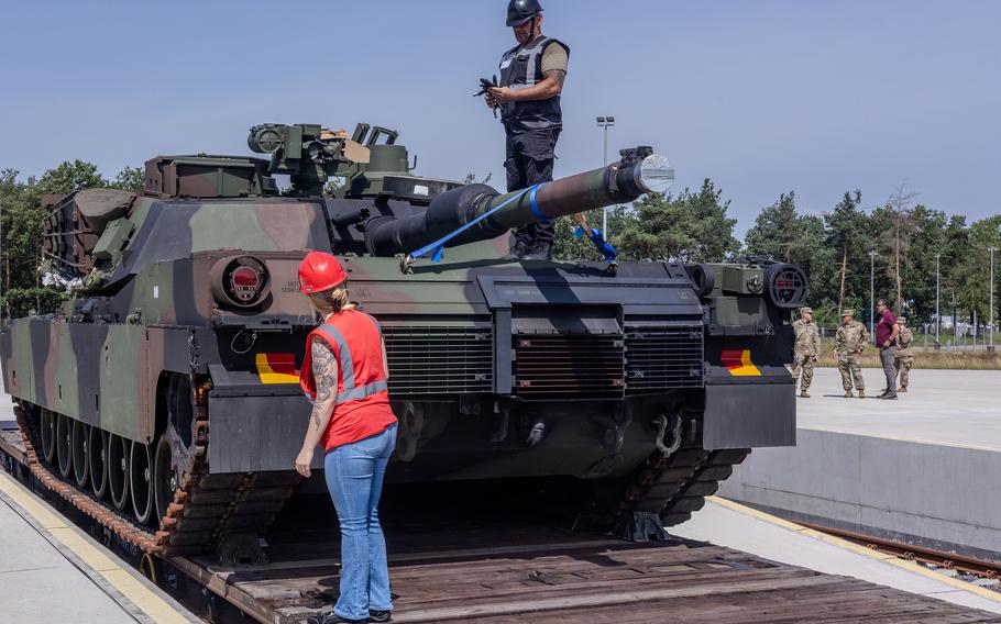 Sarah Floyd and the production control team inspect an M1 Abrams tank.