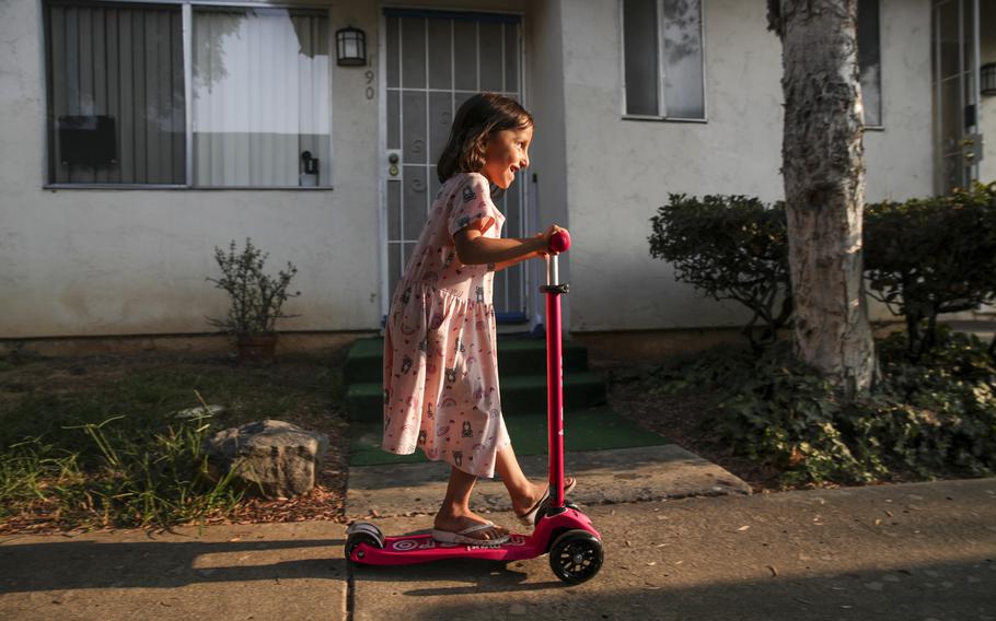 Afghan refugee Aqsa Sadat, 6, in her apartment complex rides a scooter, given to her by the members of Helping El Cajon Refugees group on Facebook, on Aug. 23, 2021, in El Cajon, Calif.