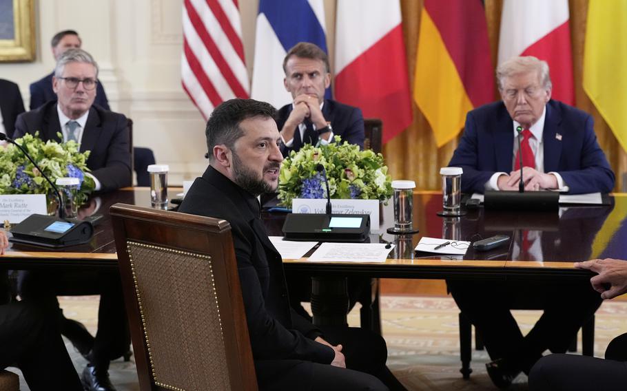 President Zelenskyy dressed in Black seated in front of British Prime Minister Starmer, French President Macron, and President Trump.
