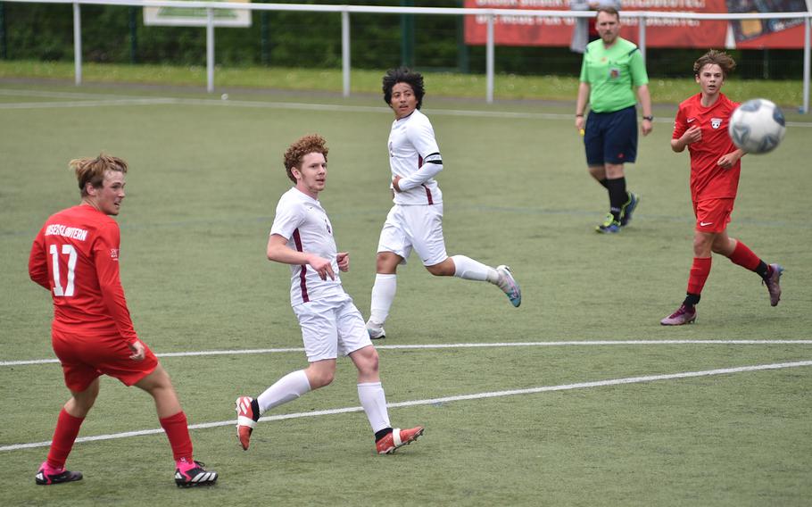 Lakenheath's Joshua Gabel, center left, watches a shot go wide during the Lancers' pool-play match against Kaiserslautern on May 15, 2023, in Reichenbach-Steegen, Germany. At left is Kaiserslautern senior Brandon Patterson.