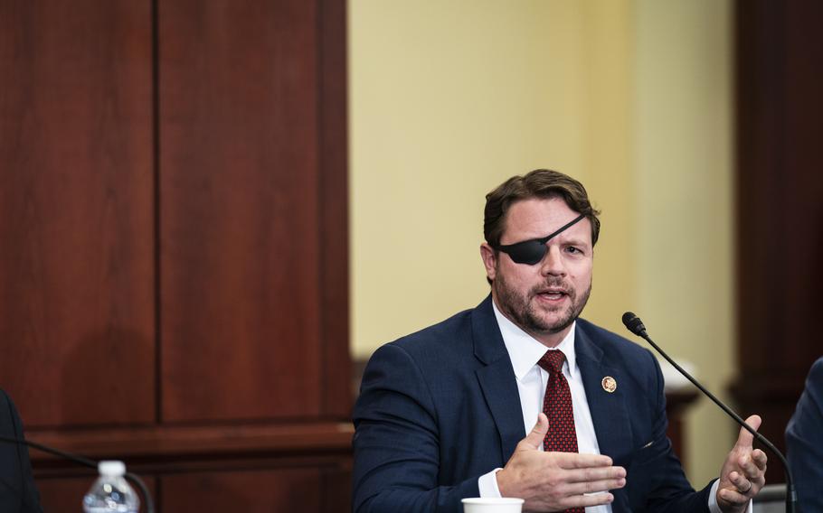 Rep. Dan Crenshaw, R-Texas, speaks during a Republican veterans roundtable in 2021. The former Navy SEAL has come to see psychedelic treatments as “chemo for your brain.”