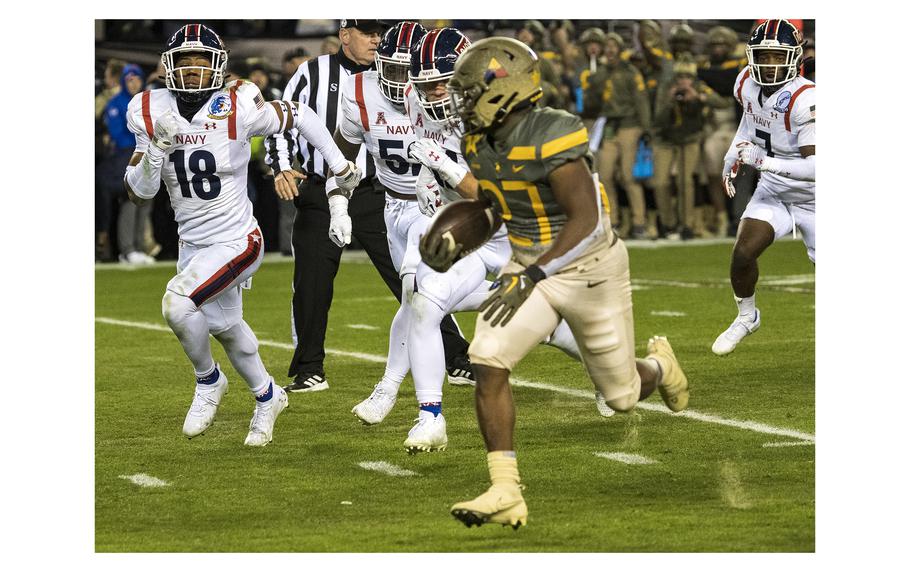 Navy Midshipmen pursue in vain as Army running back Markel Johnson runs in for a touchdown in overtime to give the Black Knights the lead during the 123rd Army-Navy football game played at at Philadelphia’s Lincoln Financial Field on Saturday, Dec. 10, 2022. After Navy tied the score 17-17 with their own touchdown, Army went on to beat Navy 20-27 in double overtime.