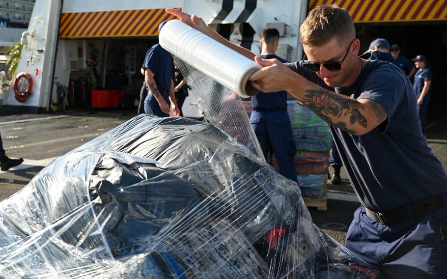 Bags of drugs being wrapped in plastic.