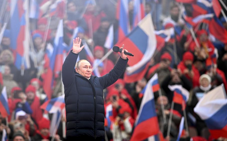 Russian President Vladimir Putin greets people after his speech at the concert marking the eighth anniversary of the referendum on the state status of Crimea and Sevastopol and its reunification with Russia, in Moscow, Russia, Friday, March 18, 2022. 