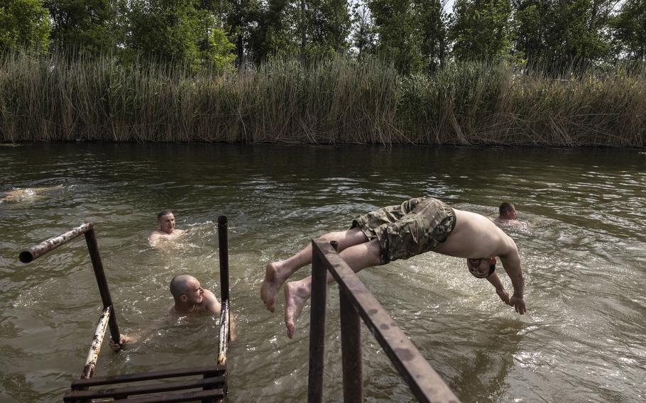 Soldiers relax and swim in a creek north of Velyka Novosilka, in an area where Ukrainians say they liberated several villages.
