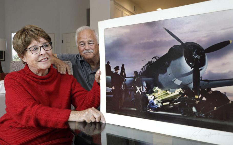 Military combat photographer Herman V. Wall captured some of the first and most famous photographs of the D-Day invasion on Normandy Beach during World War II, but that same day he lost a leg during the battle. Wall’s daughter Katherine Wall Panatone, far left, and her husband Steve Peck, center left, have co-written a book about her father’s heroics and the active working life he had after his injury called “Herman V Wall, Standing on One Leg.” Wall Panatone looks at her father’s photo of a Vultee Vengeance on an airfield in Britain, which was used in an advertisement by Vultee and won a major advertising award.