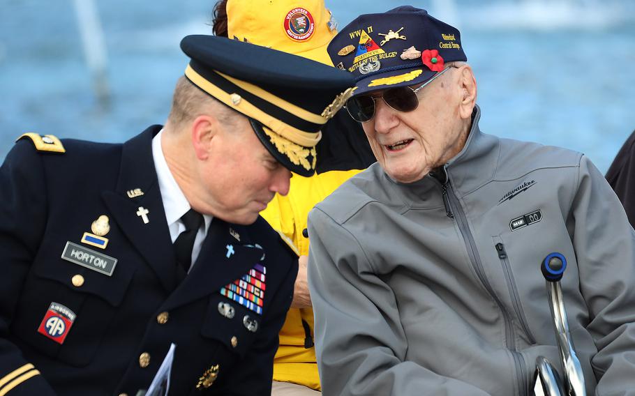 World War II veteran Harry Miller talks with Chaplain (Lt. Col.) Will Horton before the Veterans Day ceremony at the National World War II Memorial in Washington, November 11, 2023.