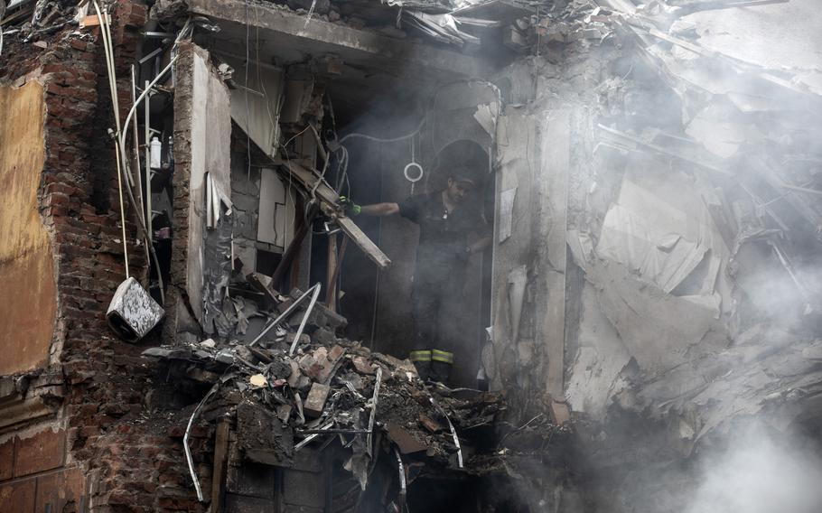 Firefighters work at a heavily damaged residential building as they look for victims after a Russian attack on Sept. 8, 2022, in the eastern city of Sloviansk, Ukraine.