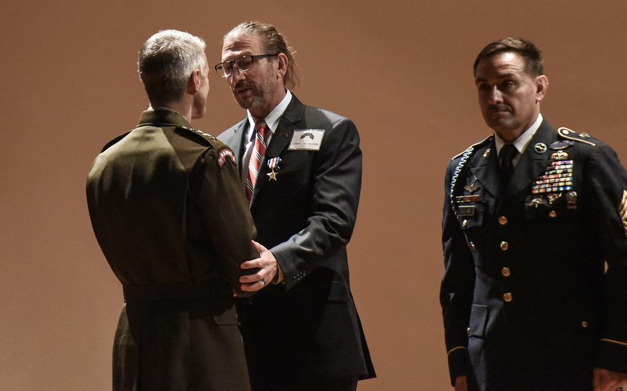 Sean T. Watson is presented the Silver Star on Friday, Oct. 1, 2021 at Fort Benning, Ga., by Army Gen. Richard Clarke, head of U.S. Special Operations Command for actions in the infamous October 1993 Battle of Mogadishu. Watson, then a sergeant first class, was a platoon sergeant with the Army’s 3rd Battalion, 75th Ranger Regiment during the battle made famous by the book and movie “Black Hawk Down.” His platoon was inserted into the operation by helicopter and later helped secure the location of the crashed MH-60 Black Hawks, which was struck by enemy rocket-propelled grenade fire. 