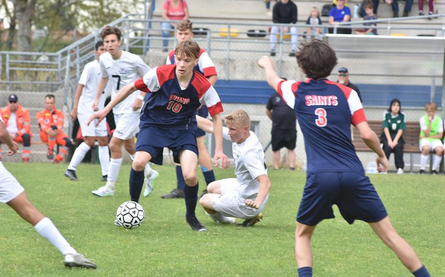 Aviano's Michael O'Brien gets away from Naples' Henri Schneider and heads towards pointing teammate Malaci Mundell during the Saints' 3-2 loss to the Wildcats on Saturday, April 16, 2022 in Aviano, Italy.