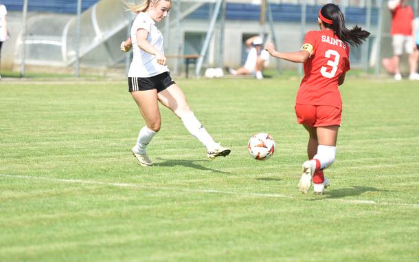 Vicenza's Maya Fitch takes a shot that Aviano's Nevaeh Zamora eventually blocks with her body in the Cougars' 3-0 victory over the Saints on Saturday, May 3, 2025, in Aviano, Italy.

Kent Harris/Stars and Stripes