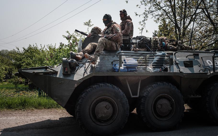 Ukrainian soldiers sit on an armoured personnel carrier (APC) near Mayaky, eastern Ukraine, on May 6, 2022, amid the Russian invasion of Ukraine. 