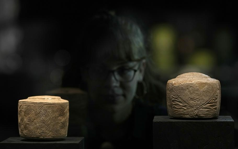 The Burton Agnes chalk drum, left, which was found in a child’s grave, 3000 BCE, with another similar ‘drum’ on display at the ‘The World of Stonehenge’ exhibition at the British Museum in London, Monday, Feb. 14, 2022. The exhibition which displays objects and artifacts from the era of Stonehenge opens on Feb. 17 and runs until  July 17, 2022. The exact use of the drum is yet to be explained. 
