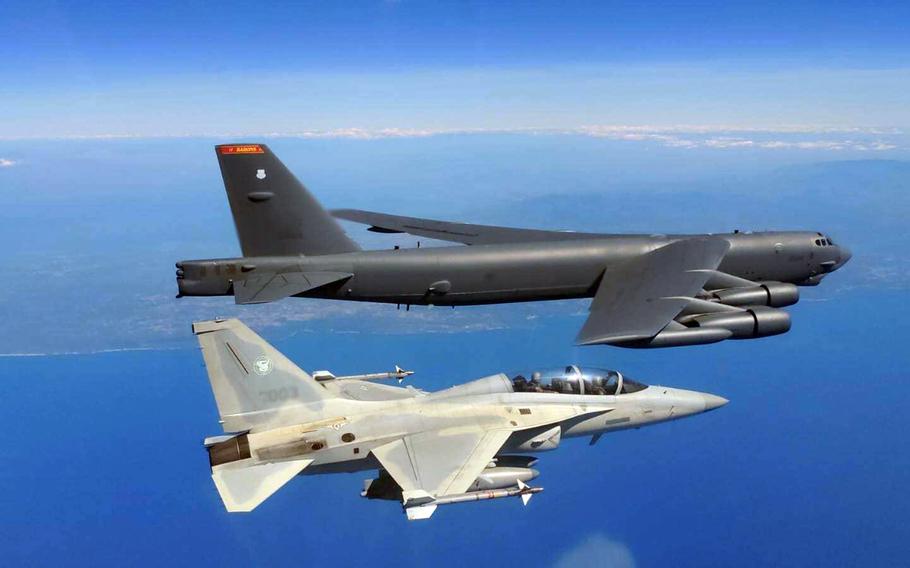 A U.S. Air Force B-52 Stratofortress bomber flies alongside a Philippine FA-50 fighter over the South China Sea, Feb. 19, 2024.