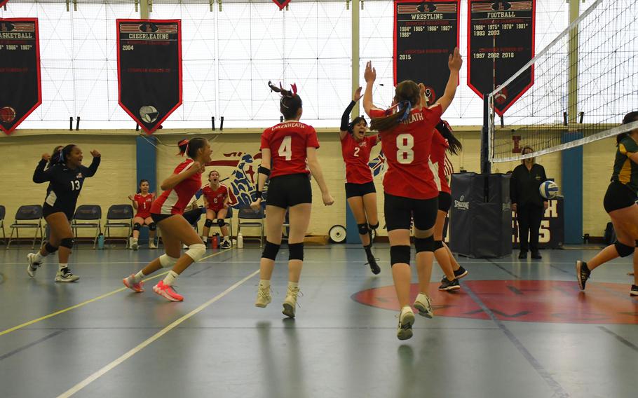 The Lakenheath Lancers' girls' volleyball team celebrates after winning a point after a long rally against the SHAPE Spartans on Saturday.