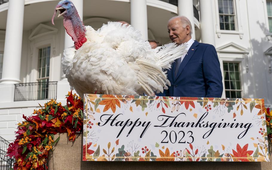 President Joe Biden stands next to Liberty, one of the two national Thanksgiving turkeys, after pardoning them during a ceremony on the South Lawn of the White House in Washington, Monday, Nov. 20, 2023. 