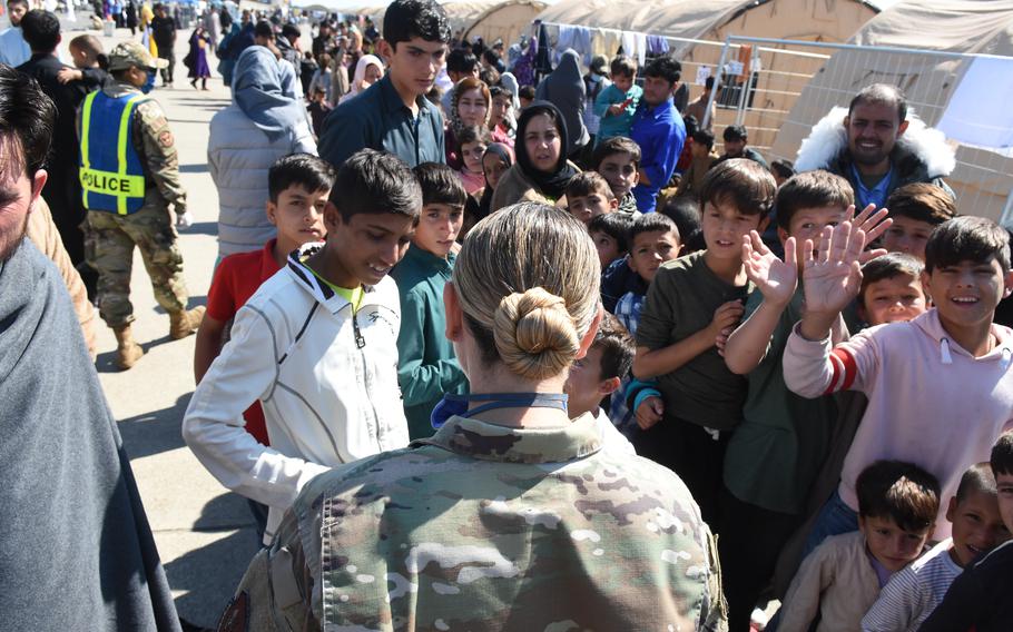 Air Force Col. Amy Glisson visits with children inside temporary living facilities at Ramstein Air Base, Germany, for evacuees from Afghanistan, Sept. 2, 2021. Glisson, the 86th Mission Support Group commander at Ramstein, is the camp commander for the day-to-day operations of receiving, housing and sending tens of thousands of evacuees on to the United States.