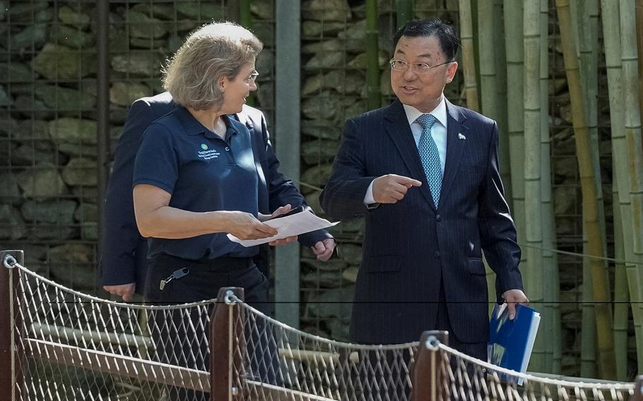 China ambassador to the United States Xie Feng walks with Brandie Smith, director of the Smithsonian’s National Zoo and Conservation Biology Institute, to announce that China will send two young giant pandas to the United States, during an update on the future of the giant panda conservation program at Smithsonian’s National Zoo in Washington, Wednesday, May 29, 2024. 