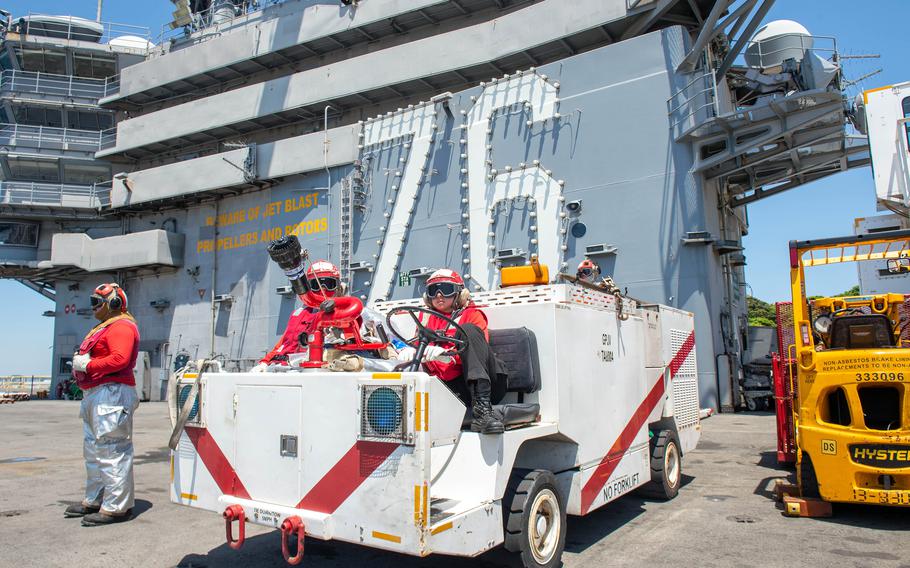 Sailors carry out a general quarters drill aboard the aircraft carrier USS Ronald Reagan at Yokosuka Naval Base, Japan, May 3, 2024.