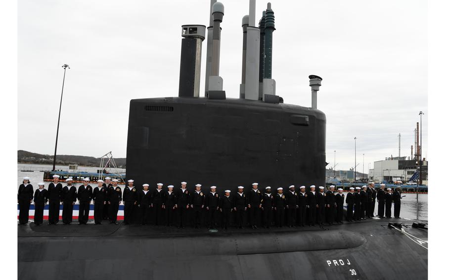 Sailors man the USS Iowa during a commissioning ceremony
