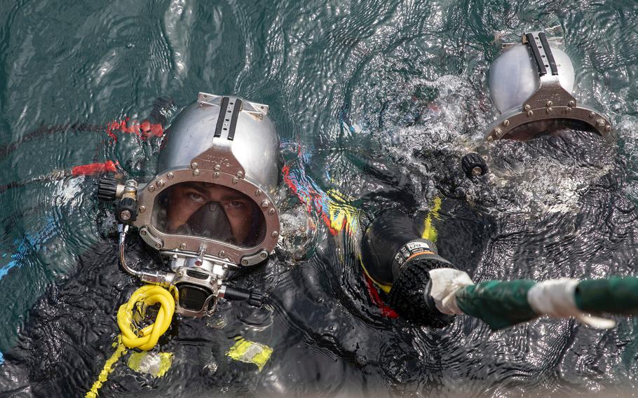 Deep sea divers with the Defense POW/MIA Accounting Agency prepare for a dive supporting the investigation of a 1971 helicopter crash site in Nha Trang Bay, Vietnam, on July 9, 2024.