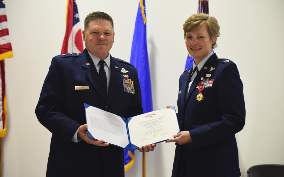 U.S Air Force Maj. Gen. James Camp, assistant adjutant general of the Ohio National Guard, presents the legion of merit to Col. Kimberly Fitzgerald for her service as commander of the 178th Wing during a change of command ceremony Nov. 7, 2021. Col. Dominic Fago assumed command of the wing from Fitzgerald.