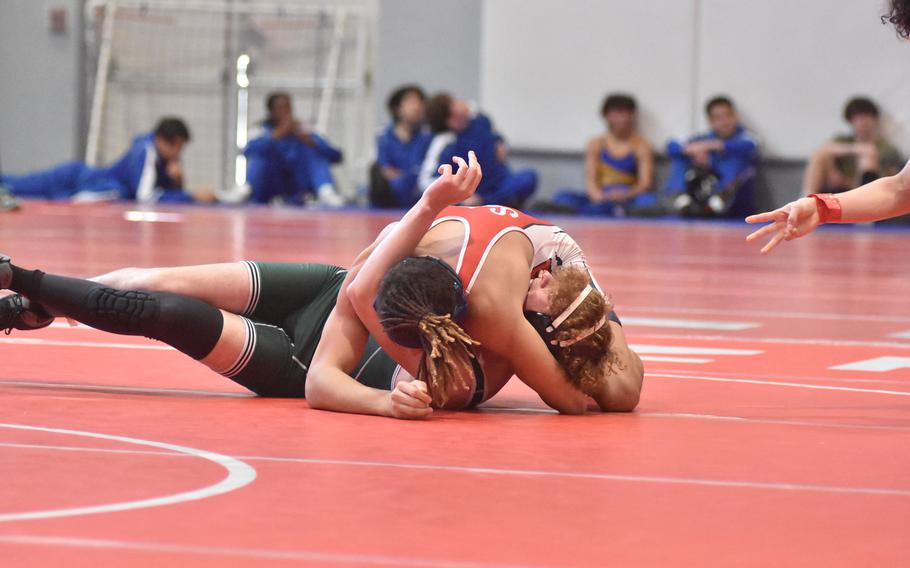 The referee signals three points for a near fall before Avaino's Javan Sherrod pins Naples' Breyden Hoffstatter in a 157-pound match Saturday, Feb. 4, 2023, at the DODEA-Europe Southern Europe regional at Aviano Air Base, Italy.