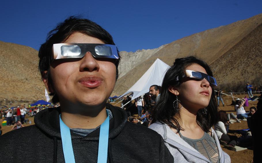 Chileans watch the sky with eclipse glasses prior to a total solar eclipse on July 2, 2019 in Paiguano, Chile. Around 25,0000 tourists arrived in Paiguano, a small town of around 1,000 inhabitants in the Elqui Valley, 650 kilometers away from Santiago. This was Earth’s only total solar eclipse of 2019 and the first one since 2017. 