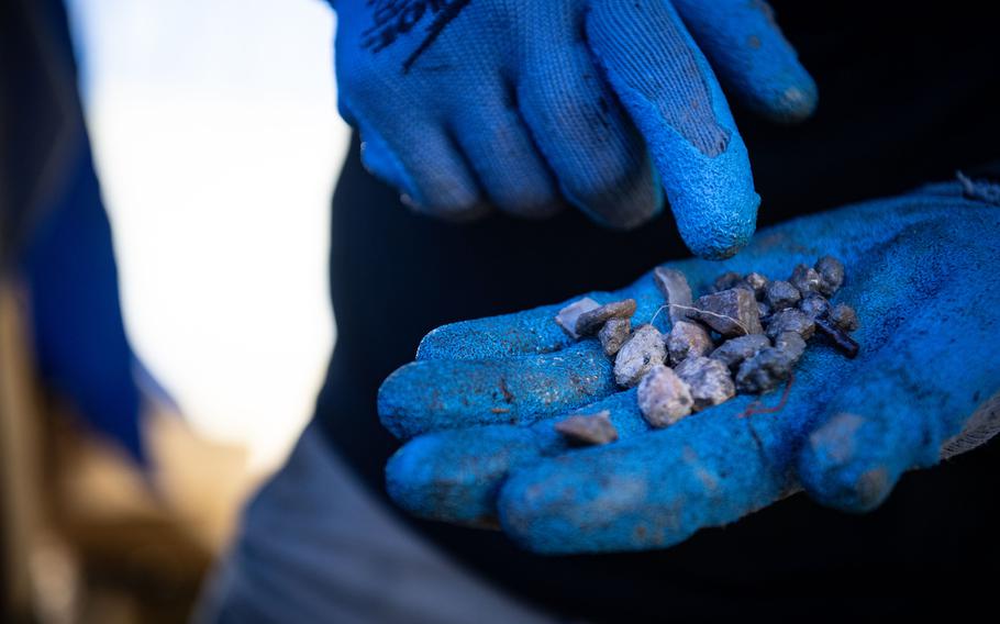 A Defense POW/MIA Accounting Agency recovery team member inspects soil during a mission in Italy, May 25, 2024. 